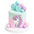 Pastel pink and mint green Unicorn Dream Cake decorated with a colorful unicorn illustration, sprinkled accents, and spherical candy toppers, perfect for custom birthday celebrations.