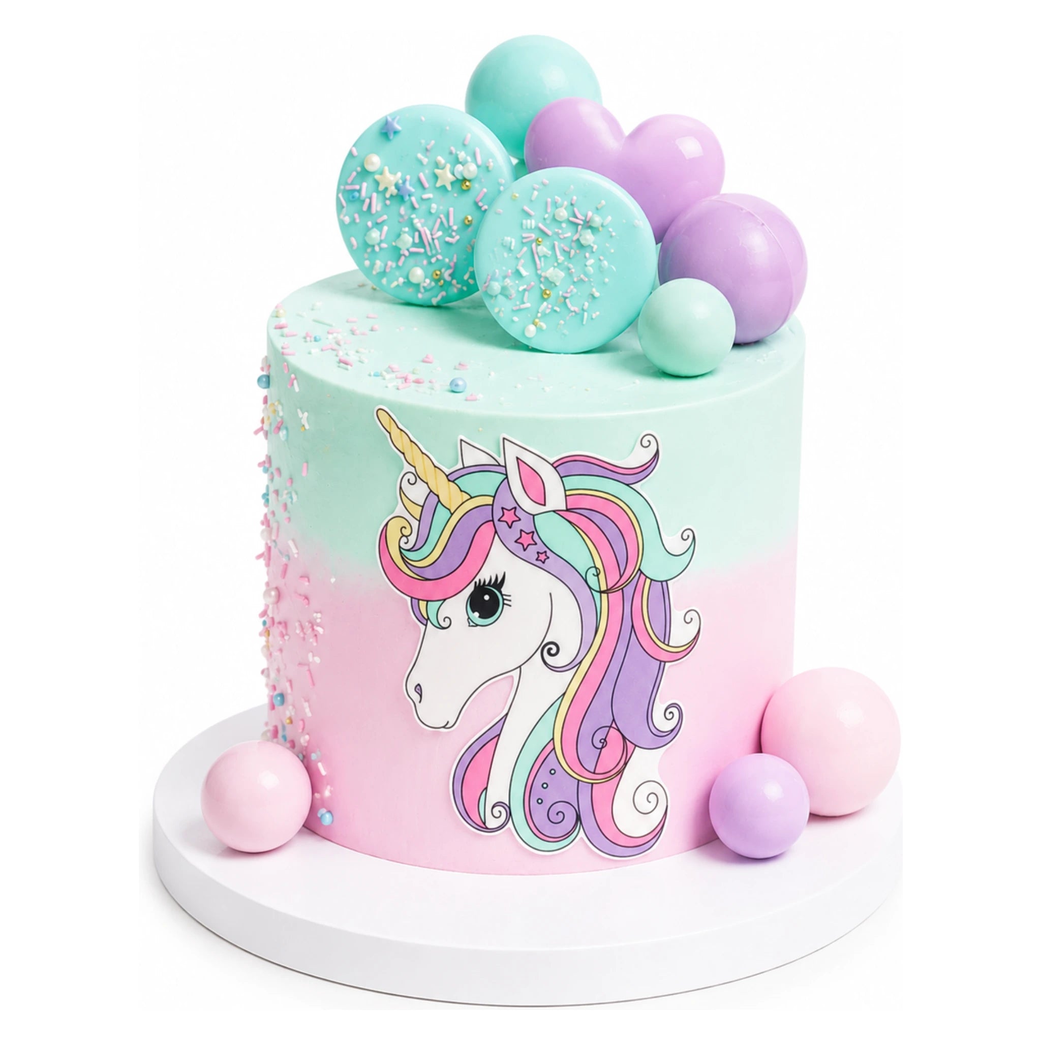 Pastel pink and mint green Unicorn Dream Cake decorated with a colorful unicorn illustration, sprinkled accents, and spherical candy toppers, perfect for custom birthday celebrations.