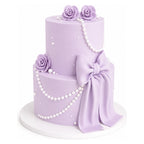 Lavender Pearl Bow Cake features two tiers covered in smooth lavender fondant, adorned with delicate pearl strands, elegant fondant roses, and a large matching bow for a sophisticated custom birthday cake.
