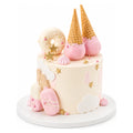 Sweet Treats Fantasy Cake featuring pastel pink and white decorations, waffle cones dipped in pink chocolate, star accents, and cloud-shaped fondant for a whimsical custom birthday cake.