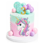 Pastel pink and mint green Unicorn Dream Cake decorated with colorful sugar pearls, round pastel candy balls, and a gold number 3 topper, perfect for a custom birthday celebration.