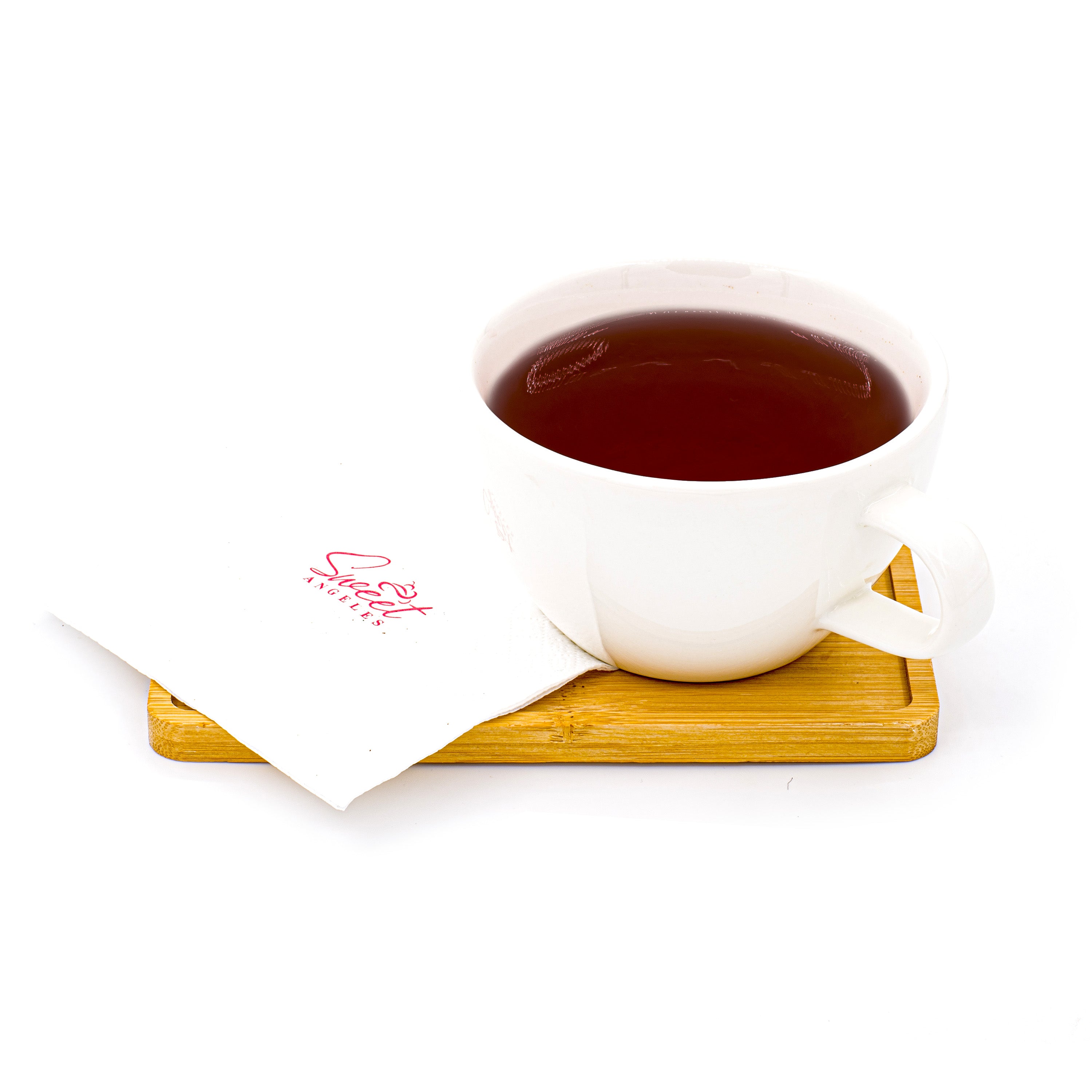 Cup of black tea in a white mug on a wooden tray with a napkin against a white background