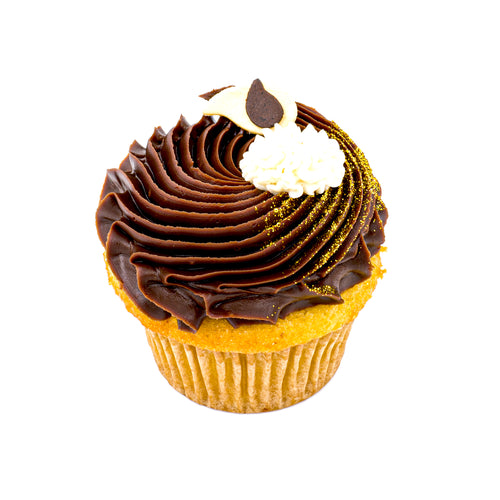 Boston cream pie cupcake with chocolate and vanilla frosting, gold sprinkles, white background