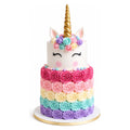 Rainbow Unicorn rosettes Tier Cake featuring a white unicorn face with closed eyes, golden horn, pastel floral decorations on top, and vibrant multicolored rosette layers.