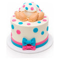 A Baby Polka Dots Cake featuring a smooth white fondant base decorated with colorful pink and blue polka dots, adorned with fondant baby legs and feet, and accented with matching bows.