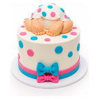 A Baby Polka Dots Cake featuring a smooth white fondant base decorated with colorful pink and blue polka dots, adorned with fondant baby legs and feet, and accented with matching bows.