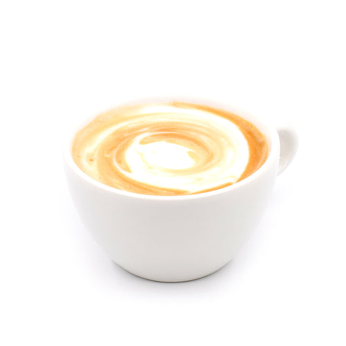 Cappuccino in a white cup with creamy milk foam swirl on a white background