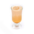 Caramel latte in a clear glass on white background, gourmet coffee drink