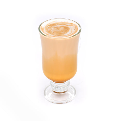 Caramel latte in a clear glass on white background, gourmet coffee drink