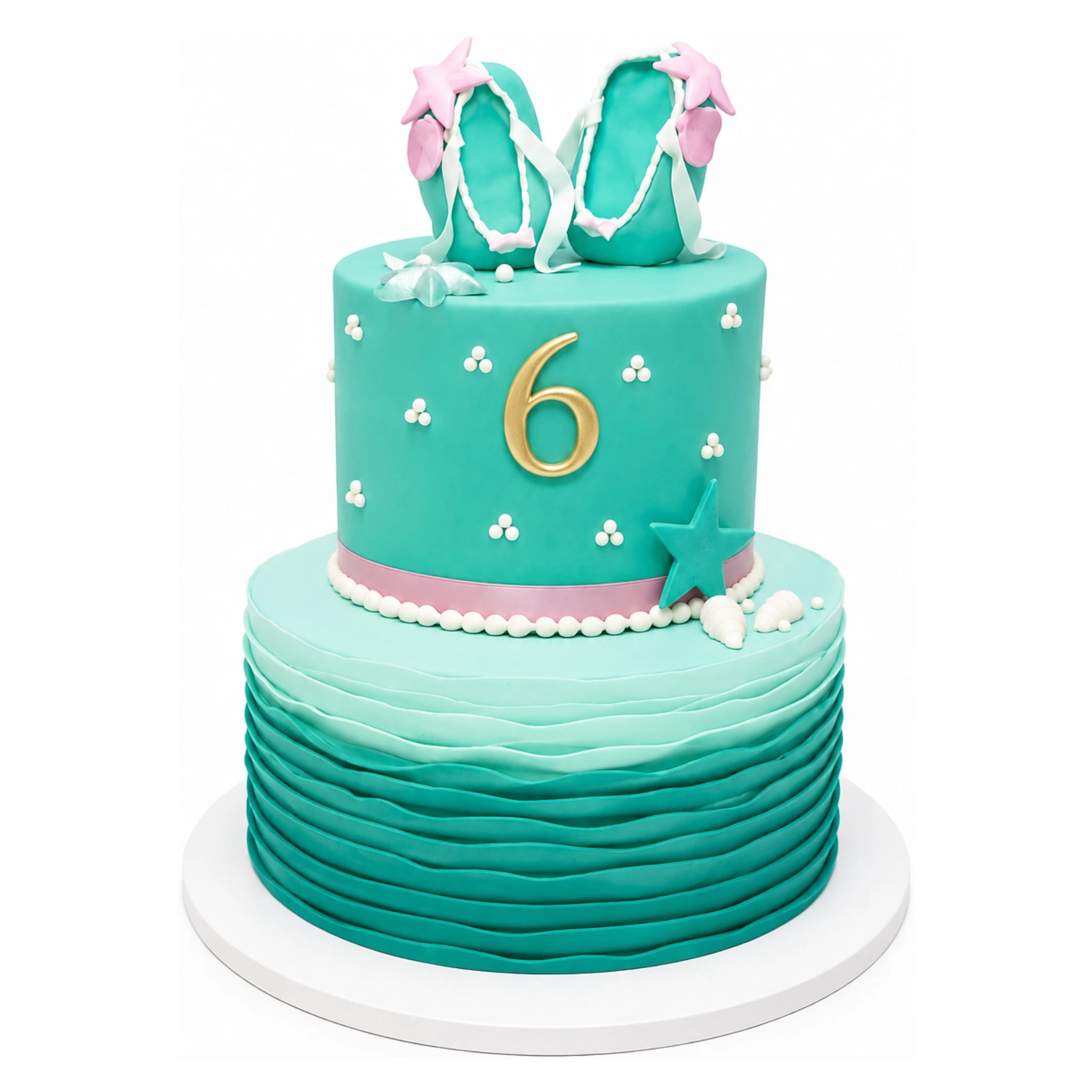 Two-tier aqua-themed cake featuring wavy ocean-like layers on the bottom tier, a "6" in gold on the upper tier, decorated with shells, stars, and a pair of teal and pink flip-flop sandals on top