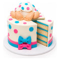 Baby Polka Dots Cake featuring white fondant with blue and pink polka dots, a blue and pink bow, and a fondant baby figure on top with visible legs and feet, custom decorated with blue cake layers inside.