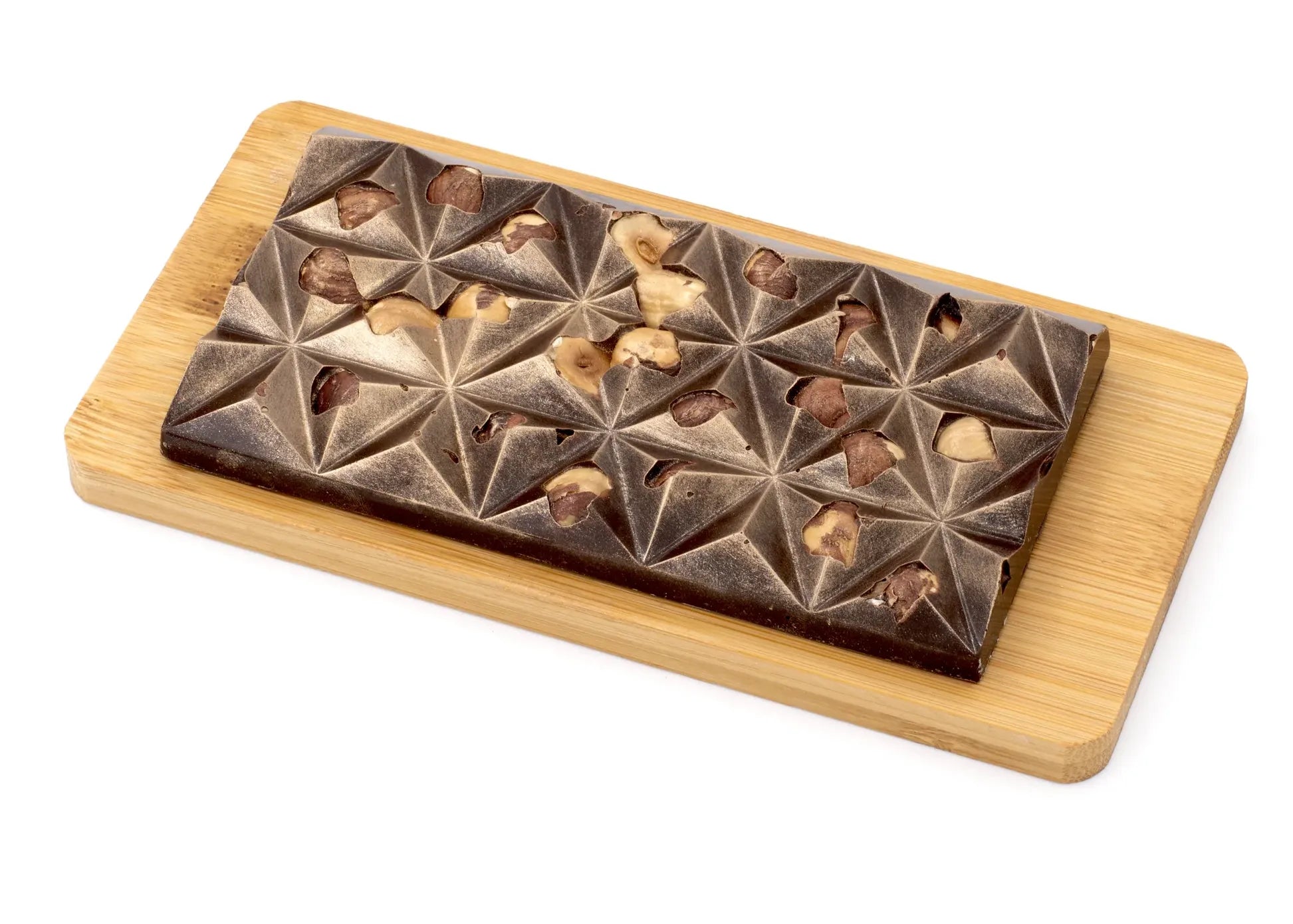 Dark chocolate hazelnut bar with geometric pattern on a wooden board
