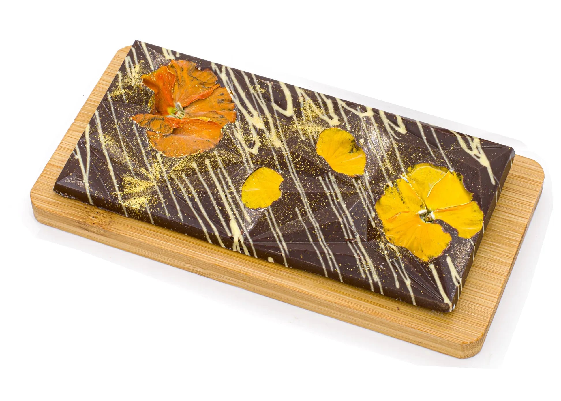 Gourmet dark chocolate bar with edible dried flowers and gold dust on wooden board