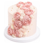 Pink Rose Garden Cake featuring delicate pink rose-shaped frosting with white cream accents and small edible pearls for an elegant custom decorated cake.