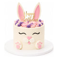 Cute Bunny Cake decorated with pink and purple frosting, bunny ears, paws, and a gold "Happy Birthday" topper, perfect for custom birthday celebrations.