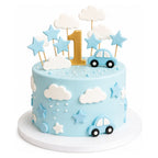 Little Cars & Clouds Cake featuring light blue fondant, white clouds, blue stars, small blue cars, and a gold number one on top, perfect for a custom birthday or celebration.