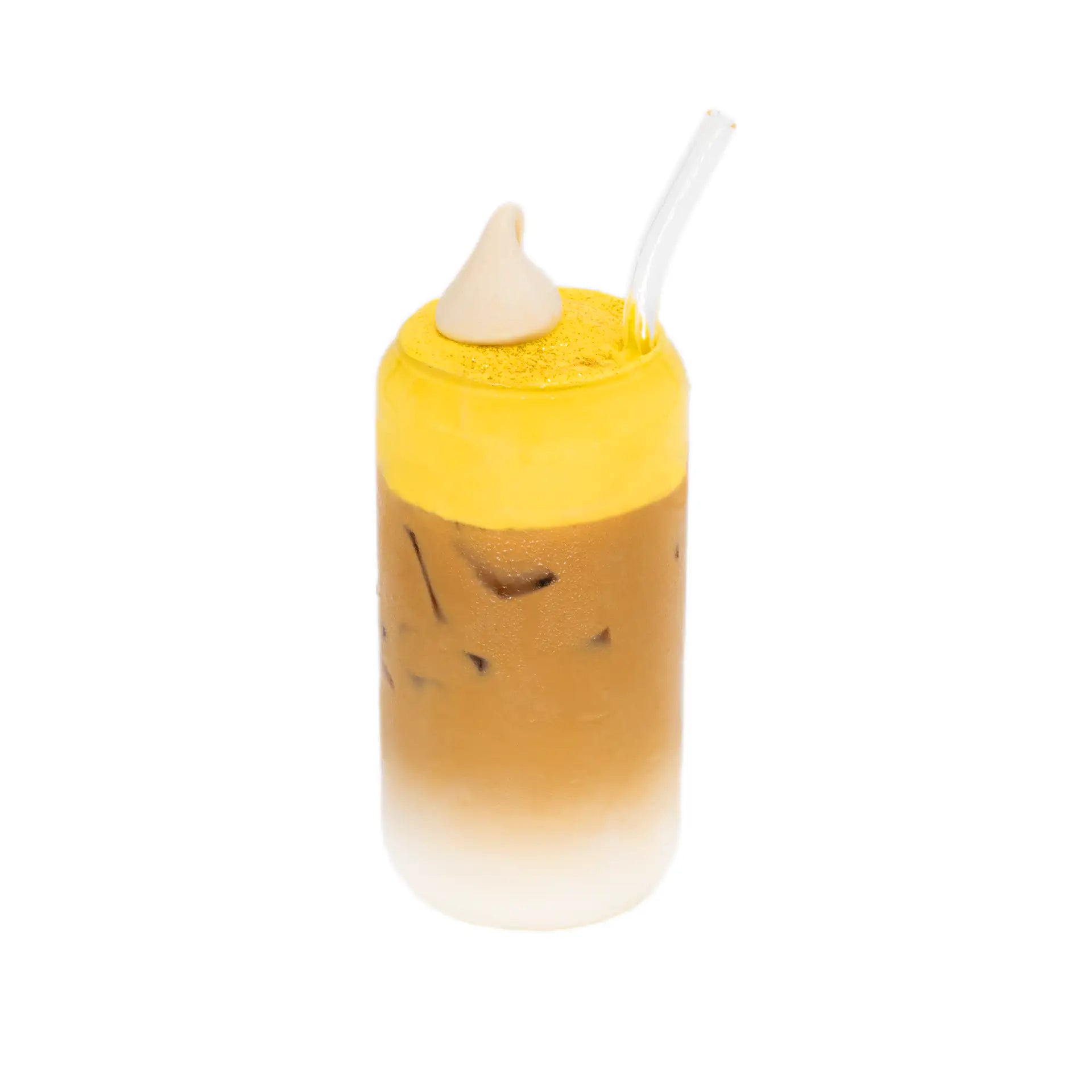 Iced mango latte in a clear glass with ice, vibrant mango layer, cream, and straw