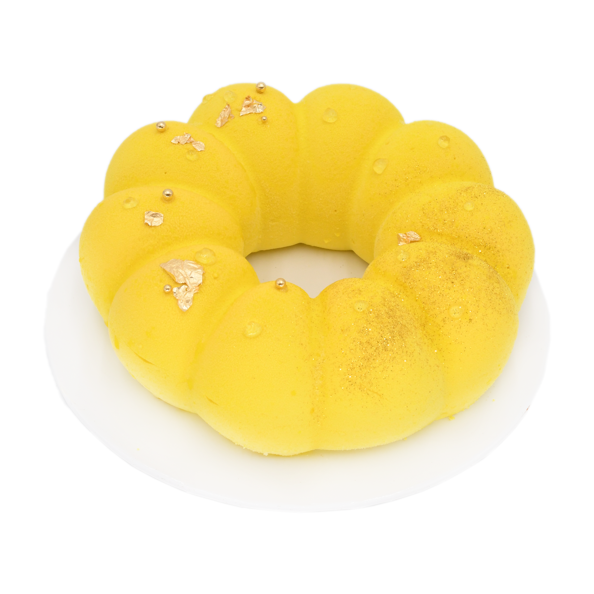 Lemon mousse cake with gold leaf and edible pearls on white plate, gourmet dessert