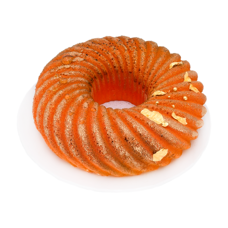 mango mousse cake with gold leaf decoration on a white plate, gourmet dessert