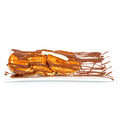 Fluffy pancakes drizzled with chocolate sauce and topped with white chocolate on a white plate