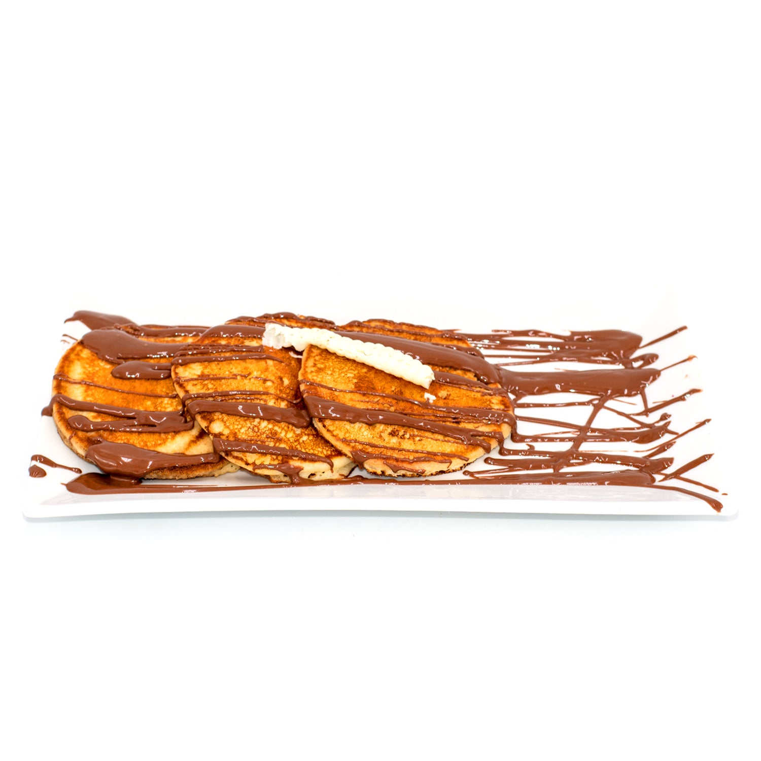 Fluffy pancakes drizzled with chocolate sauce and topped with white chocolate on a white plate