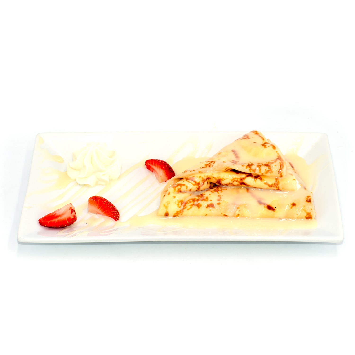 Tres leches crepes topped with cream, sliced strawberries, and whipped cream on a white plate