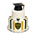 Two-tier Beverly Hills High School Graduation Cake featuring elegant white fondant with gold and green stripes, quilted top tier with gold accents, a graduation cap topper, and a diploma decoration, custom cakes baked fresh in Beverly Hills with luxury touch on Rodeo Drive.