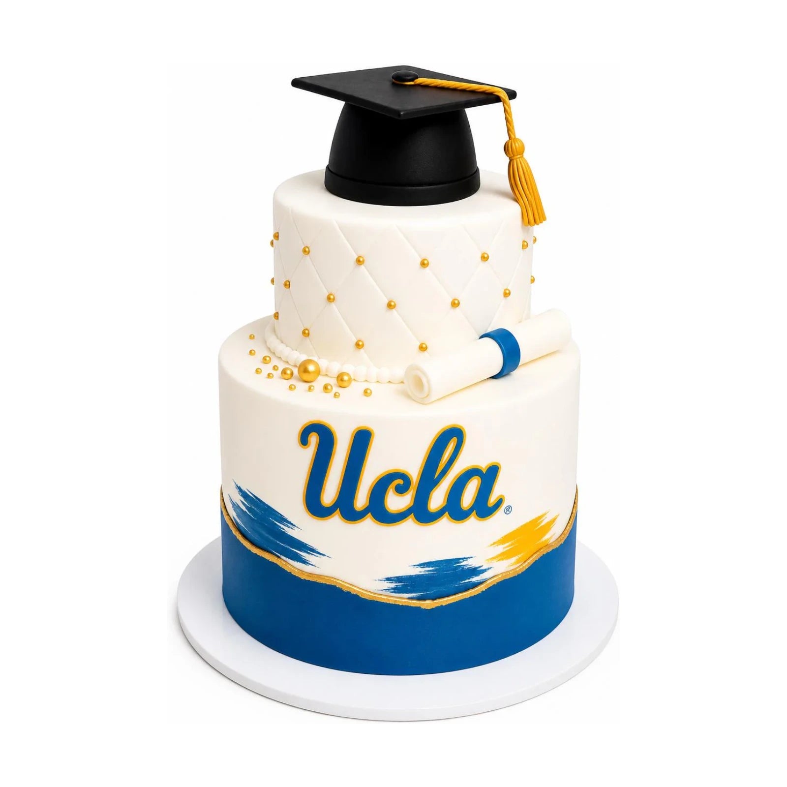 Elegant two-tier UCLA Graduation Cake – Brushstroke Edition with white quilted fondant, gold accents, brushstroke details, and a black graduation cap topper, luxury custom cakes baked fresh in Beverly Hills.
