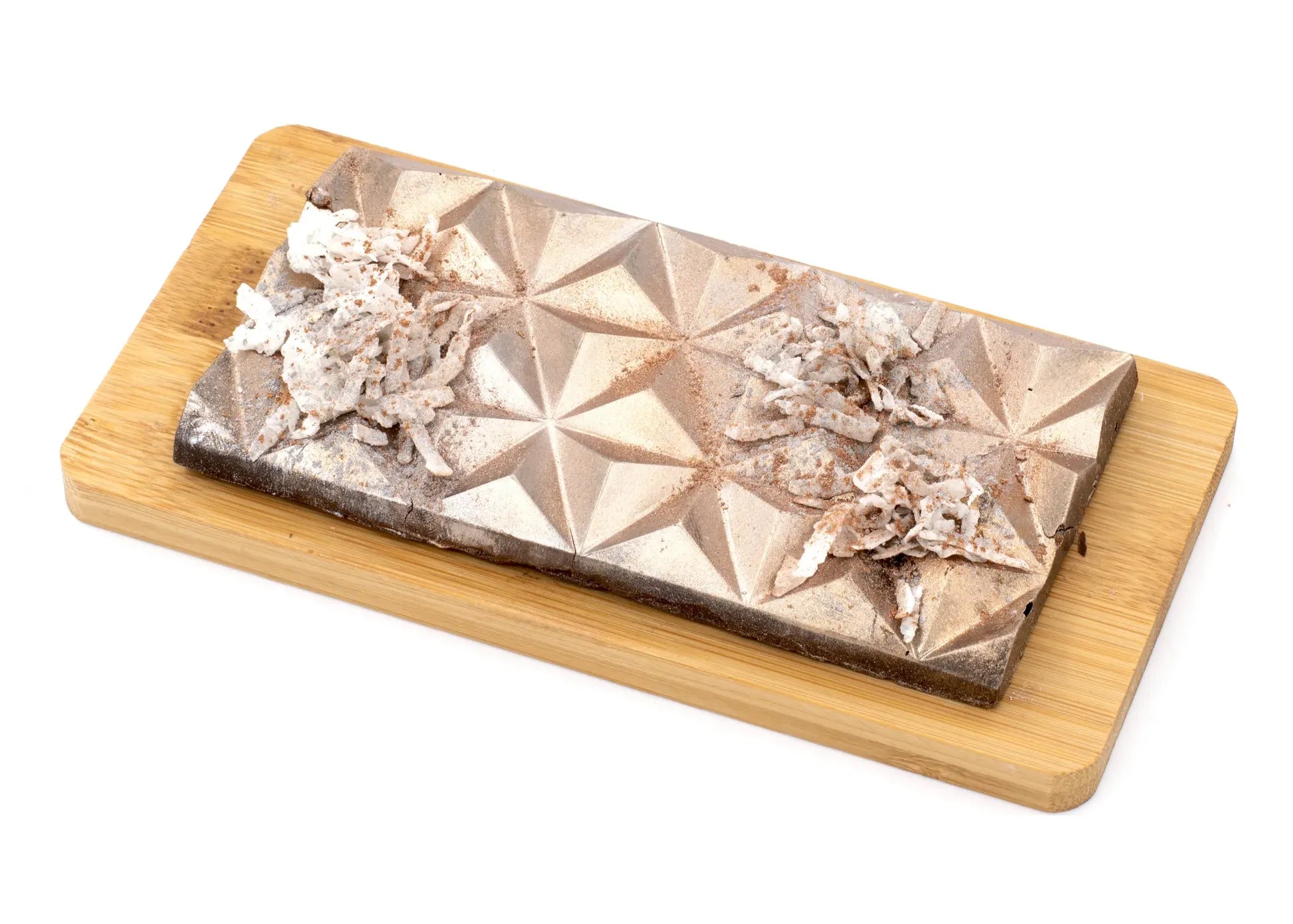 Gourmet chocolate bar with geometric design and shredded coconut topping on a wooden board